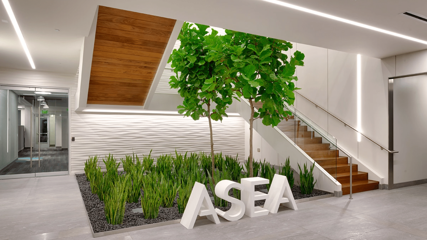 The lobby in ASEA Global Headquarters with its staircase with plants beside it.